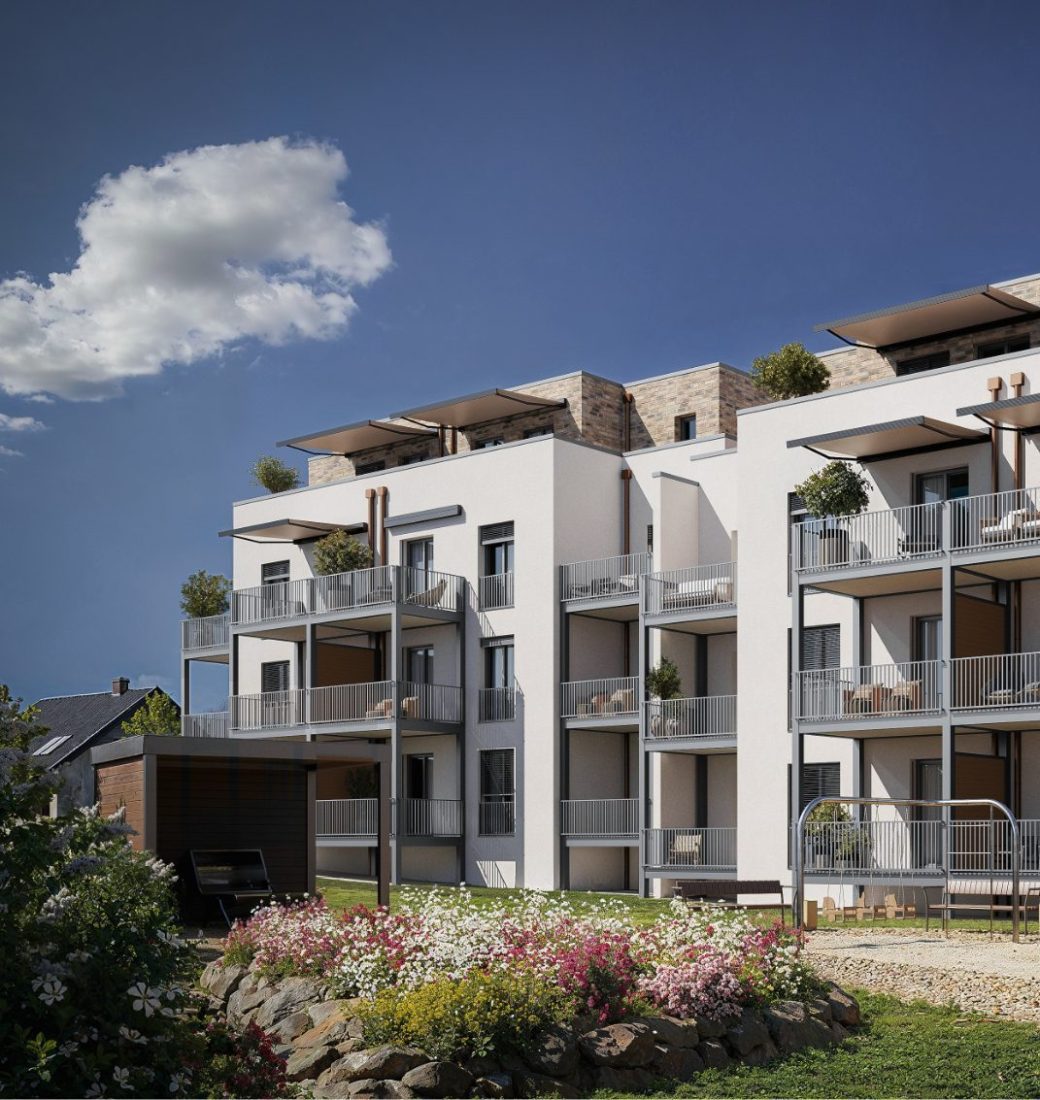 Ansicht auf Nullenergiehaus, gemütliche Balkone und ein Spielplatz mit viel Begrünung