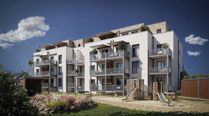 Ansicht auf Nullenergiehaus, gemütliche Balkone und ein Spielplatz mit viel Begrünung